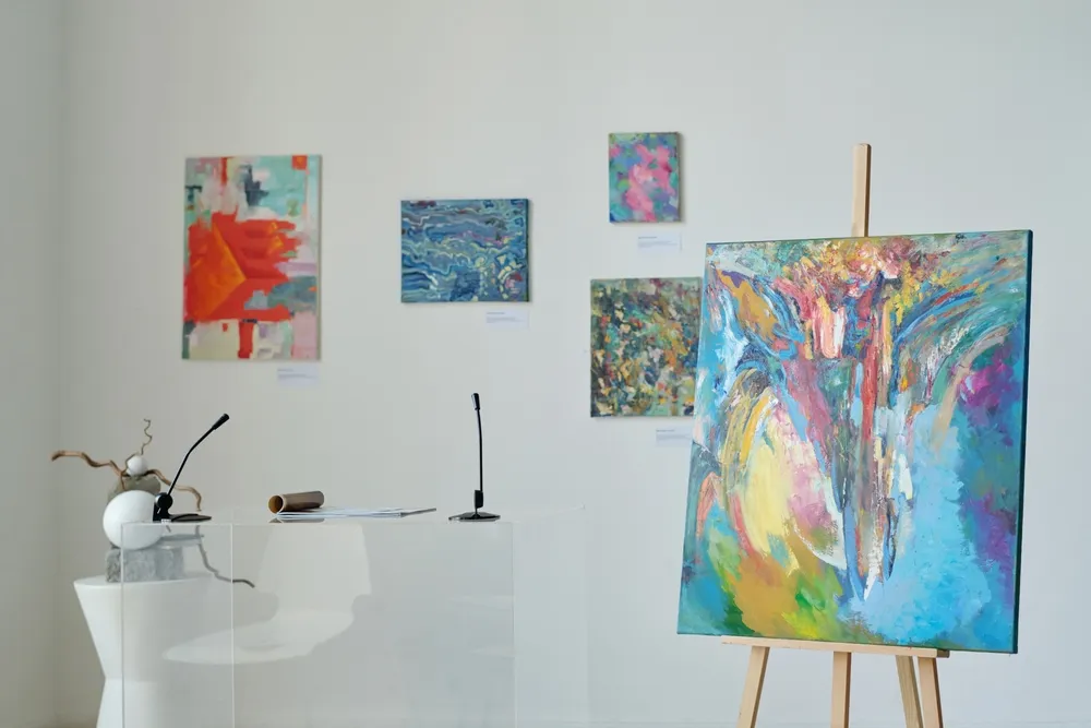 Pieces of art hung on white walls